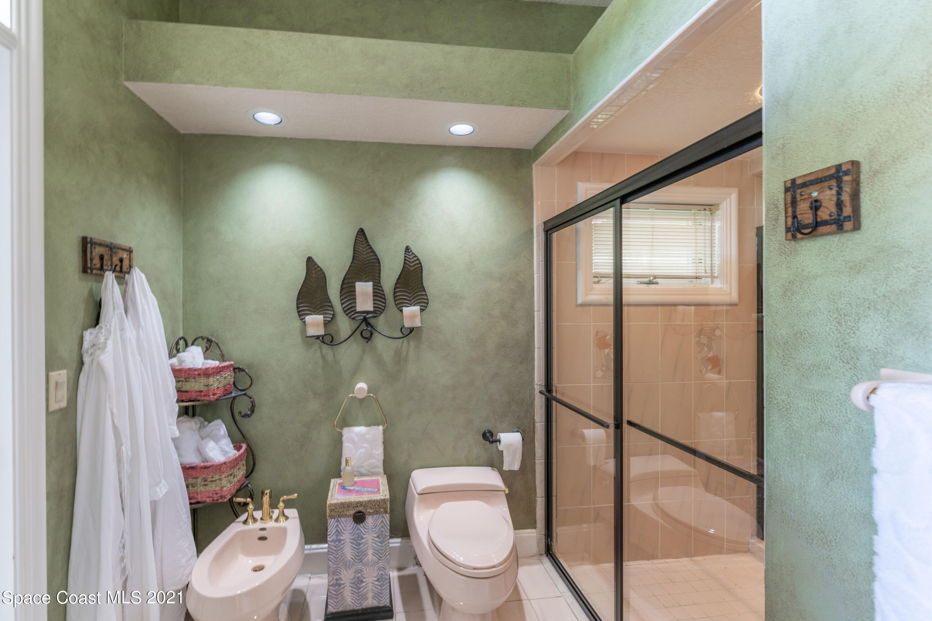 3835 Raney Road Titusville, FL 32780 - Photo 35 of 55 a bathroom with a toilet sink and mirror