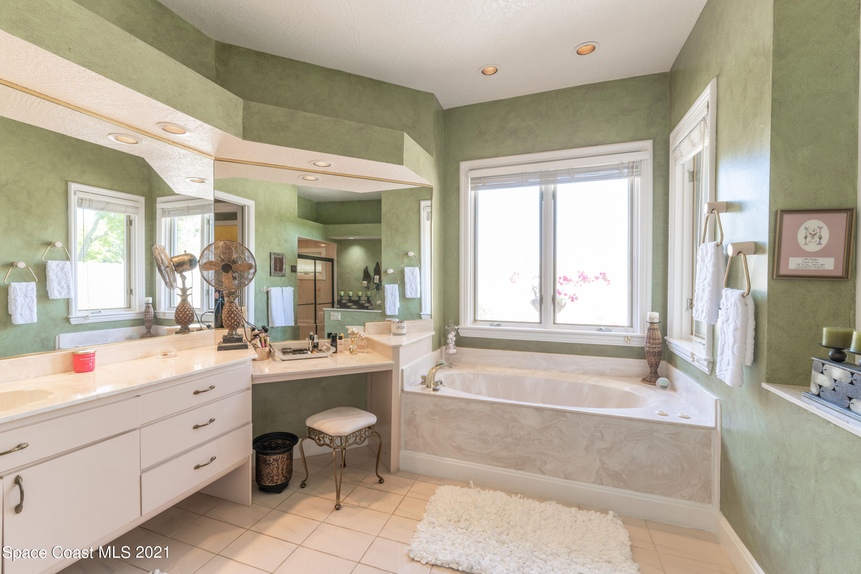 3835 Raney Road Titusville, FL 32780 - Photo 36 of 55 a bathroom with a tub sink toilet and mirror