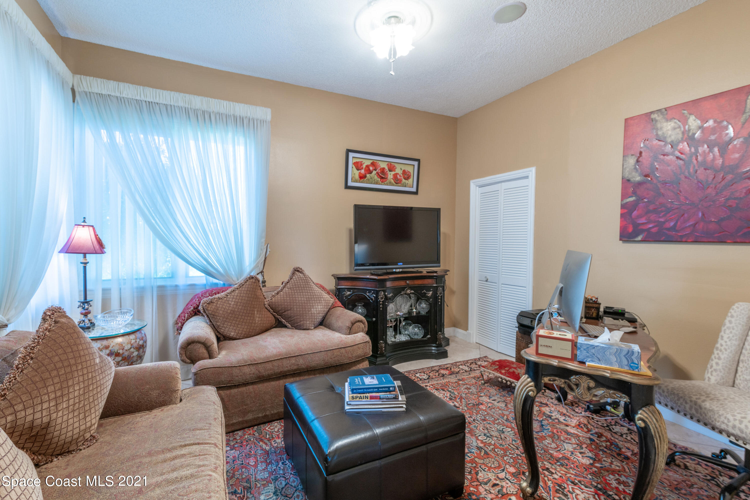 3835 Raney Road Titusville, FL 32780 - Photo 38 of 55 a living room with furniture and a flat screen tv