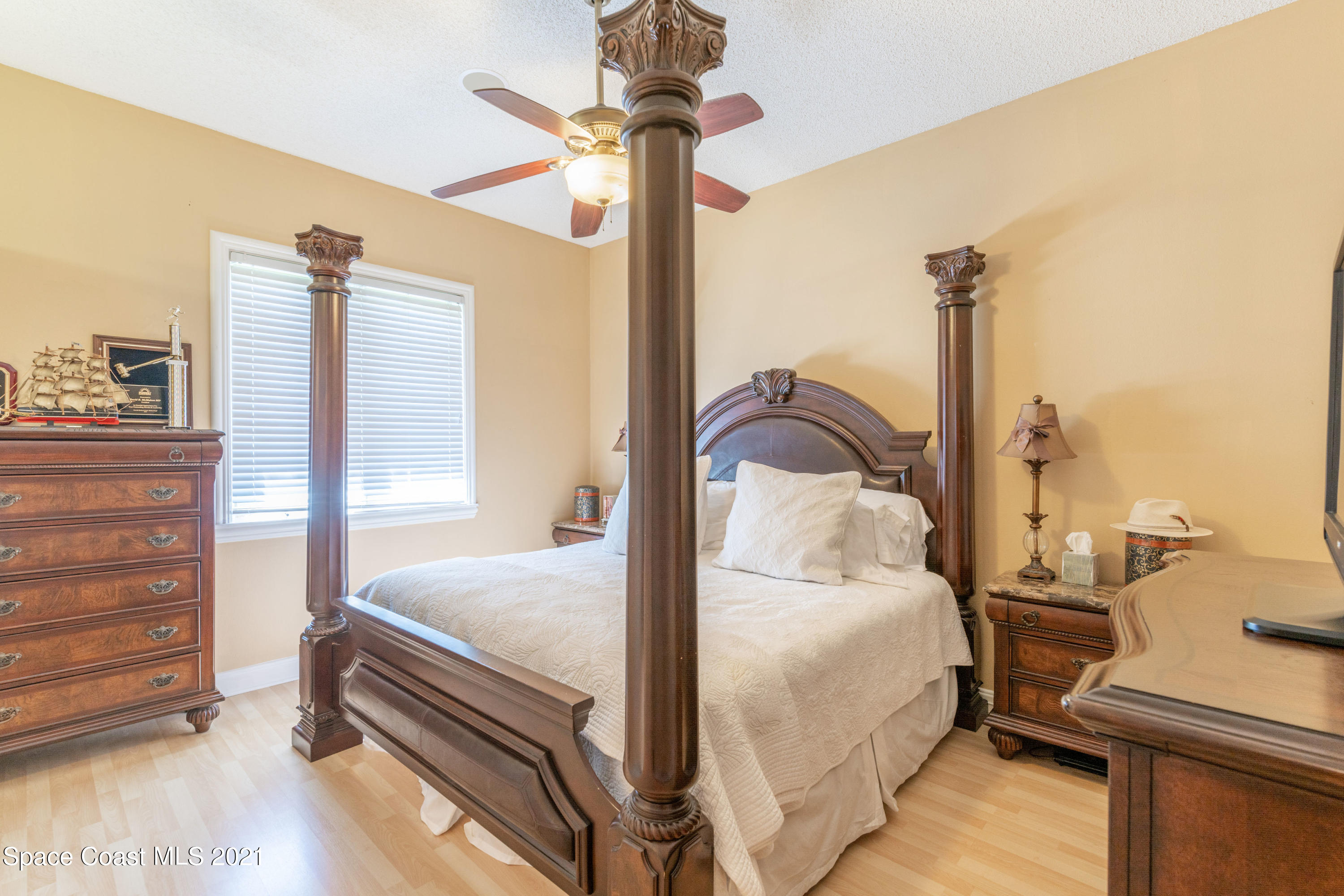 3835 Raney Road Titusville, FL 32780 - Photo 40 of 55 a bedroom with a bed and a chandelier