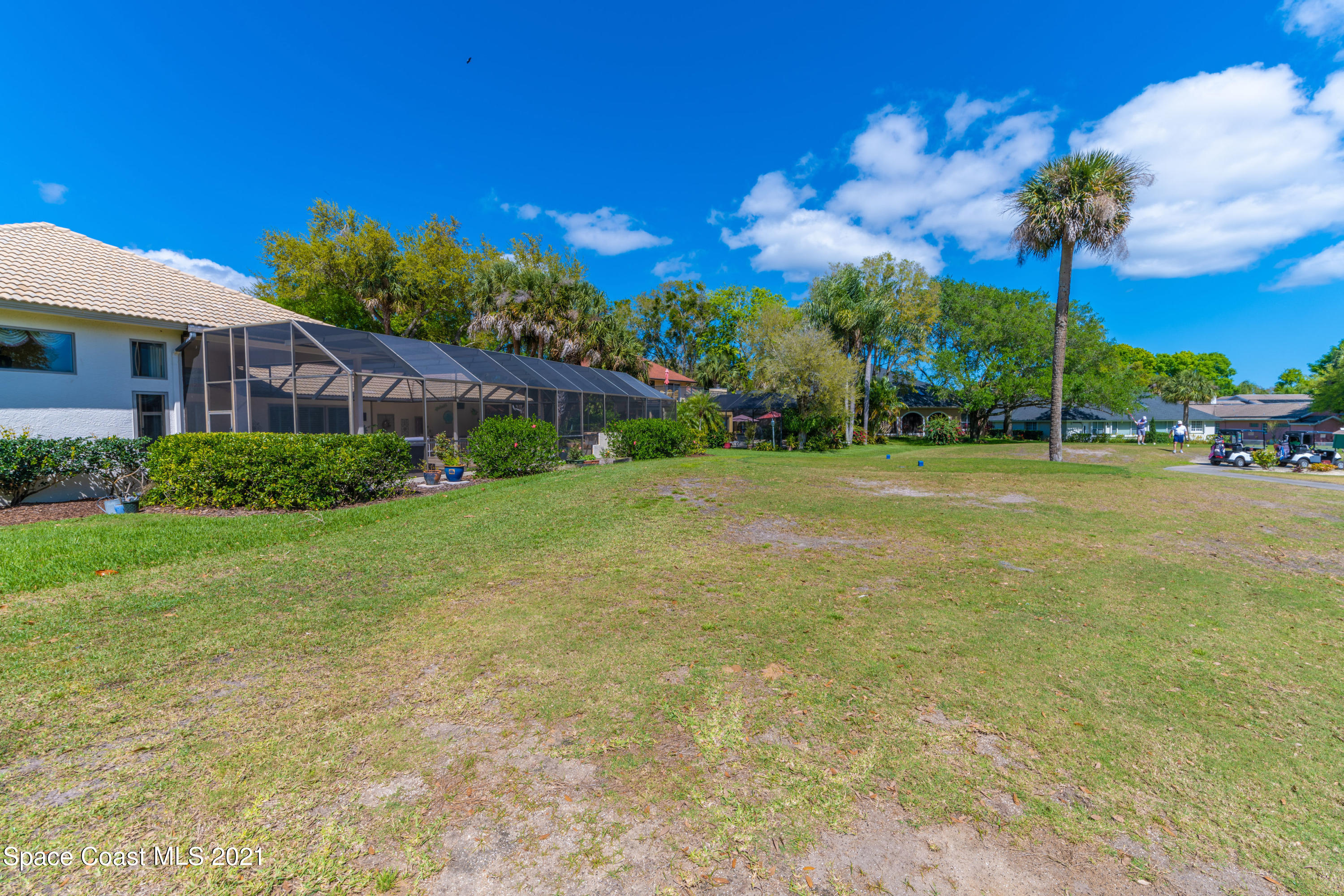 3835 Raney Road Titusville, FL 32780 - Photo 49 of 55 a view of a house with a big yard and palm trees