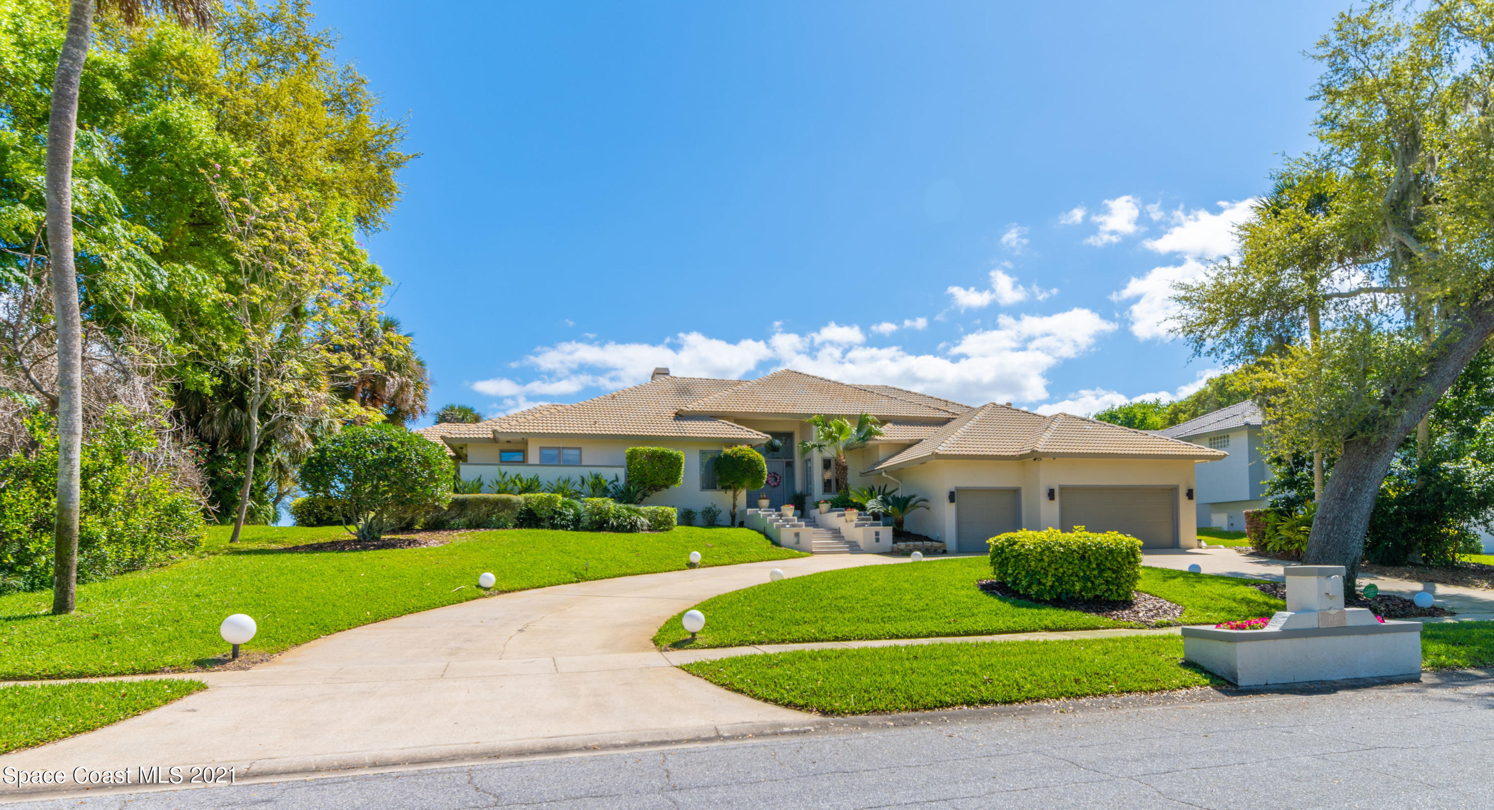 3835 Raney Road Titusville, FL 32780 - Photo 54 of 55 a view of a white house with a big yard and potted plants