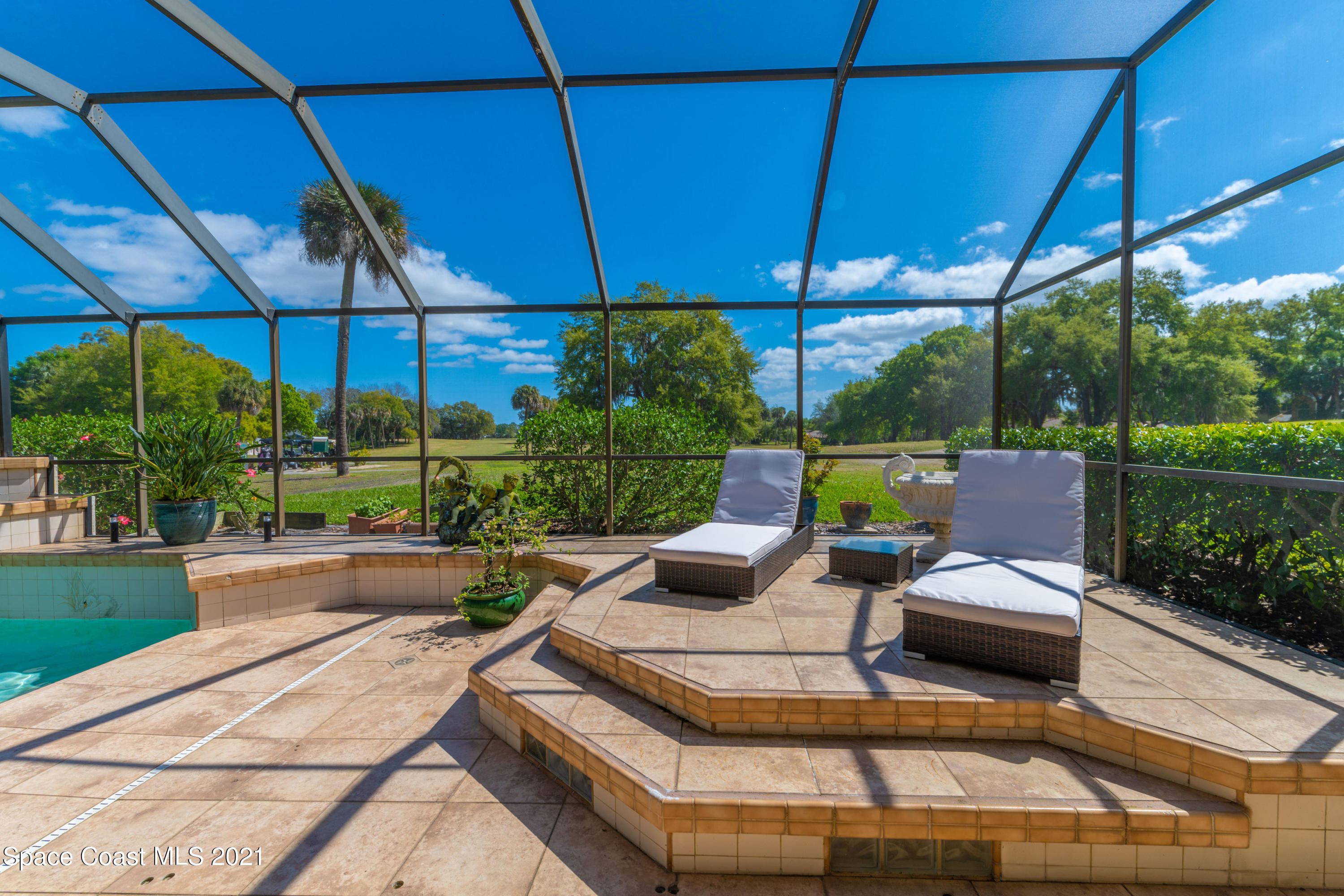 3835 Raney Road Titusville, FL 32780 - Photo 8 of 55 a view of a patio with couches chairs under an umbrella
