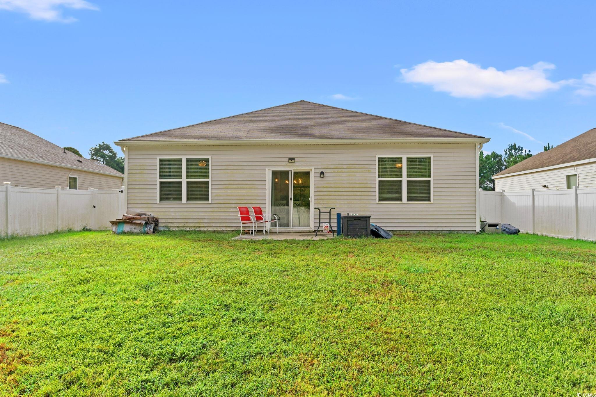 236 Legends Village Loop Myrtle Beach, SC 29579 - Photo 18 of 23 Rear view of house featuring a fenced backyard and a patio