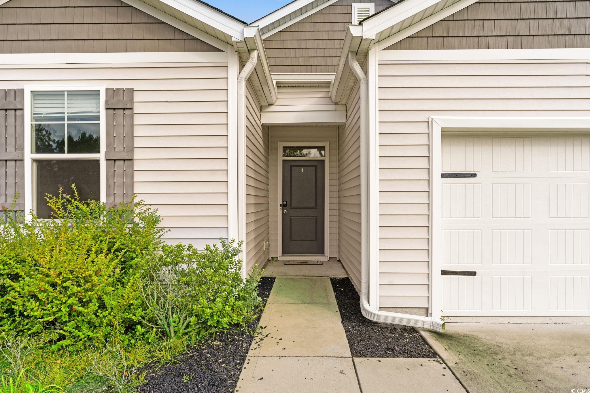 Property entrance with a garage