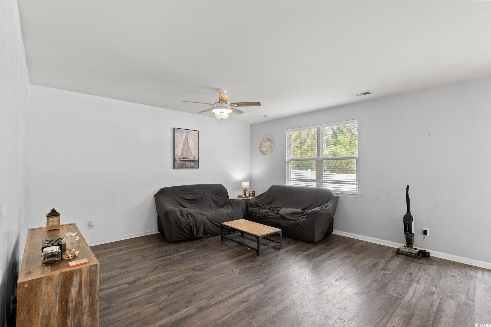236 Legends Village Loop Myrtle Beach, SC 29579 - Photo 8 of 23 Living area with dark wood-style floors and a ceiling fan