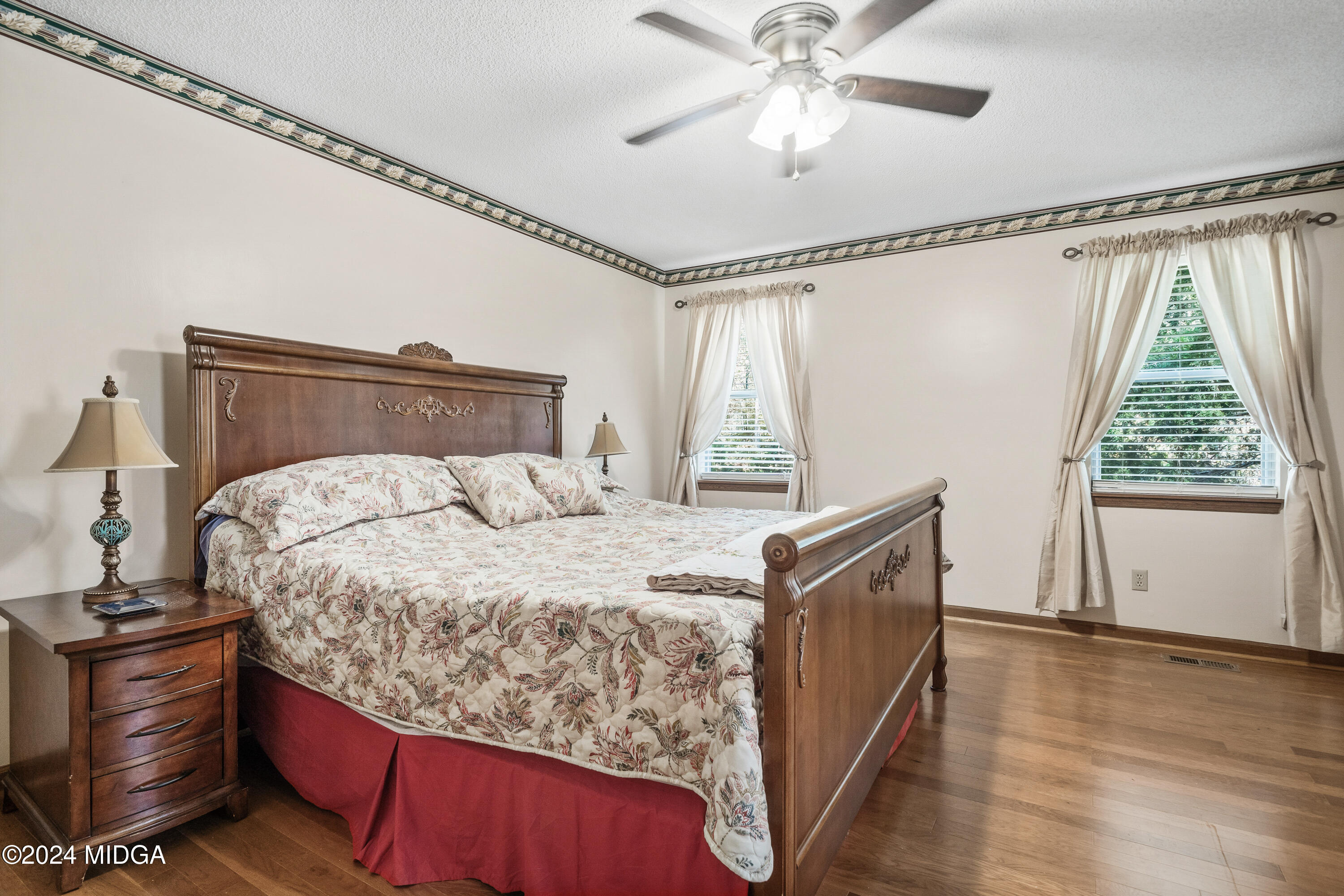 112 Whitehead Place Gray, GA 31032 - Photo 19 of 36 a bed sitting in a bedroom next to a window