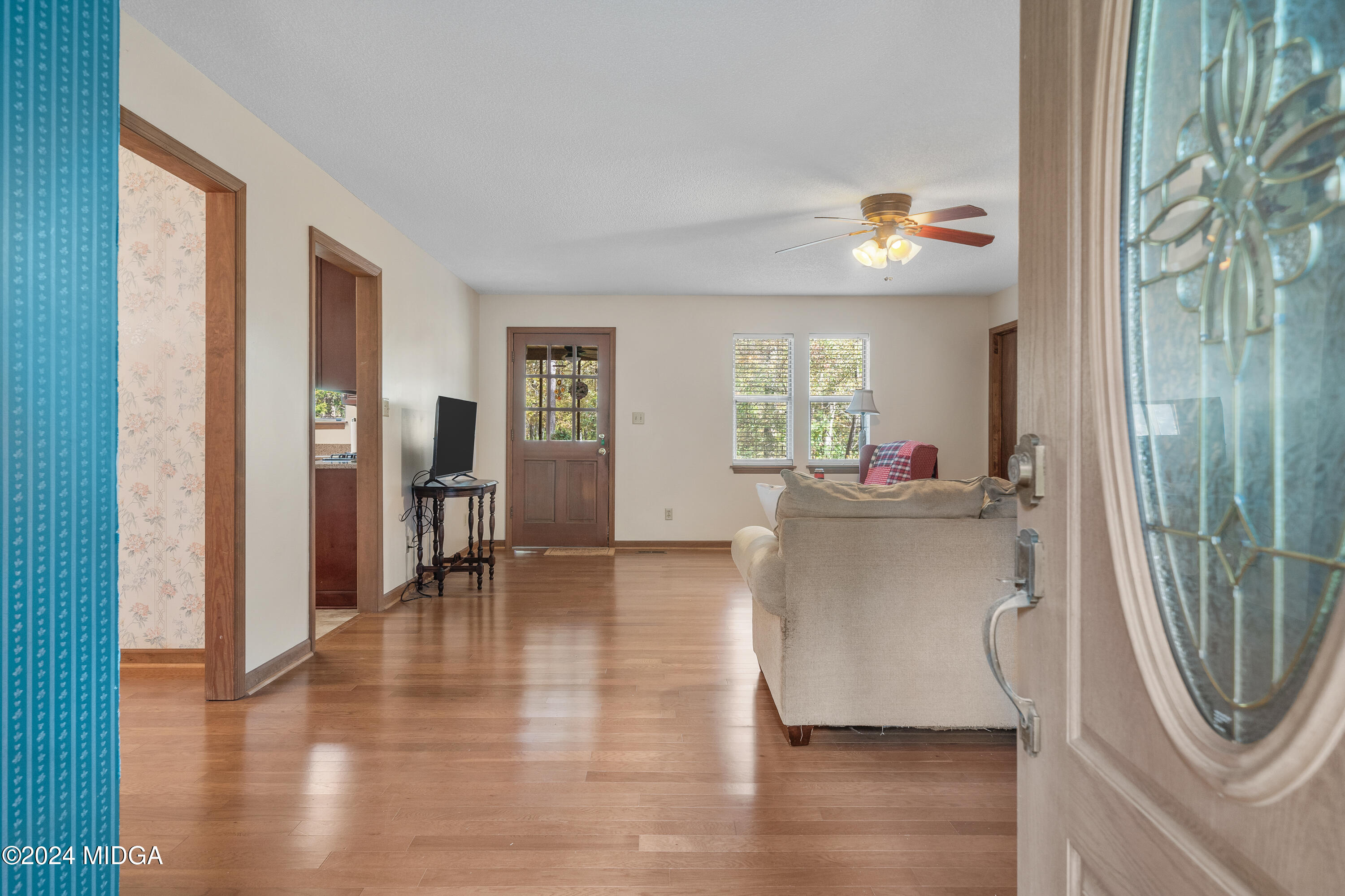 112 Whitehead Place Gray, GA 31032 - Photo 4 of 36 a view of a hallway with wooden floor and a dining room