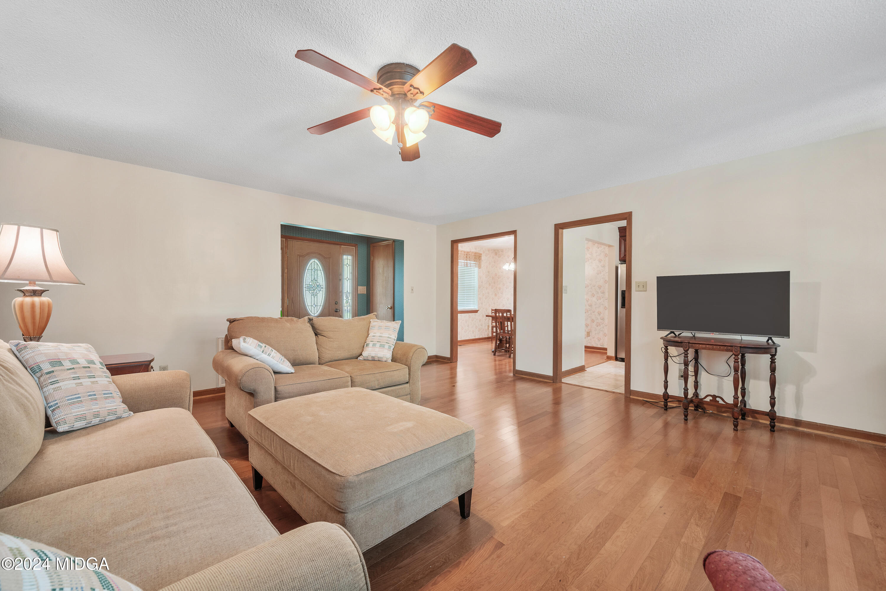 112 Whitehead Place Gray, GA 31032 - Photo 8 of 36 a living room with furniture and a wooden floor