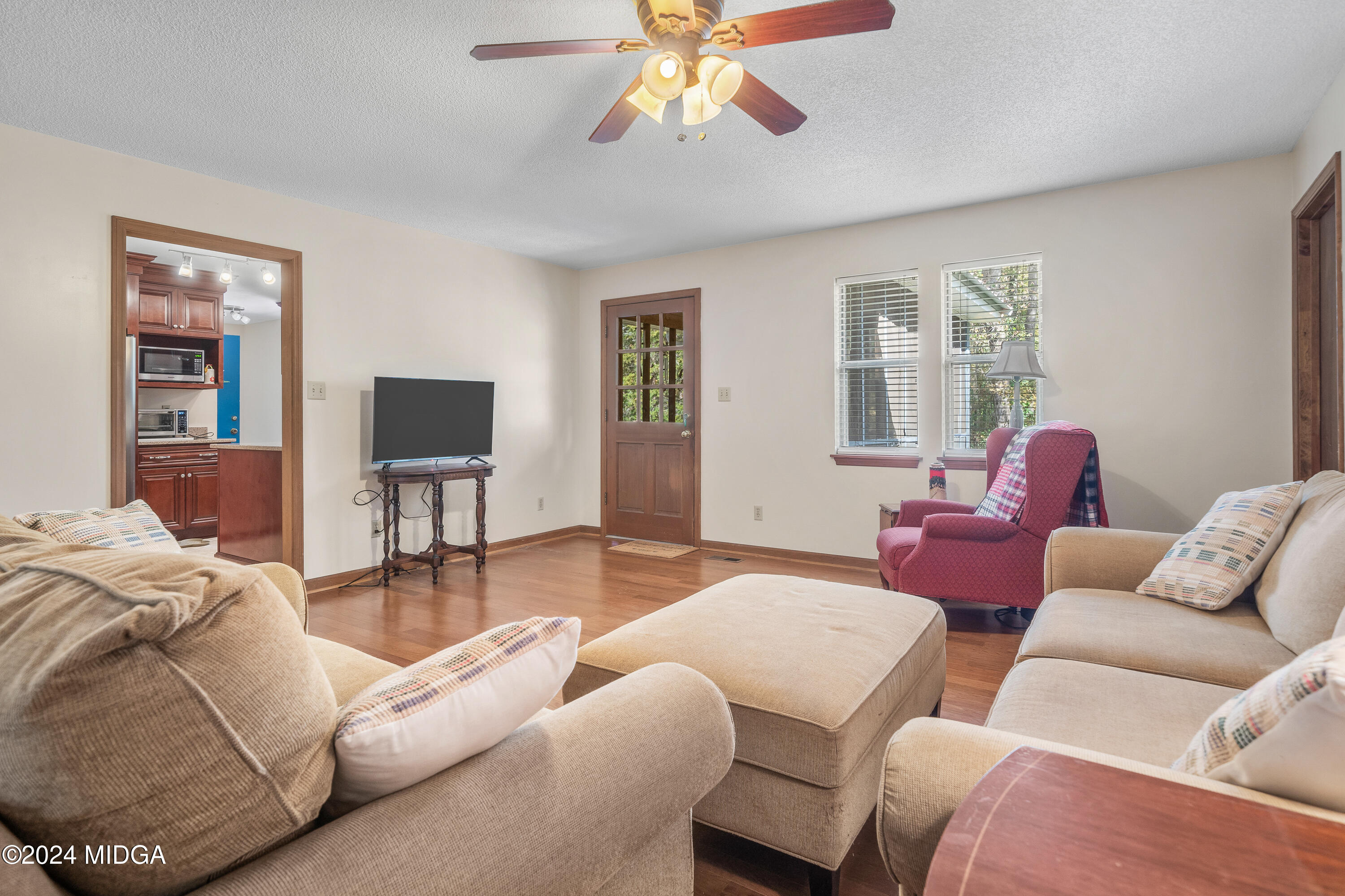 112 Whitehead Place Gray, GA 31032 - Photo 9 of 36 a living room with furniture a large window and a flat screen tv