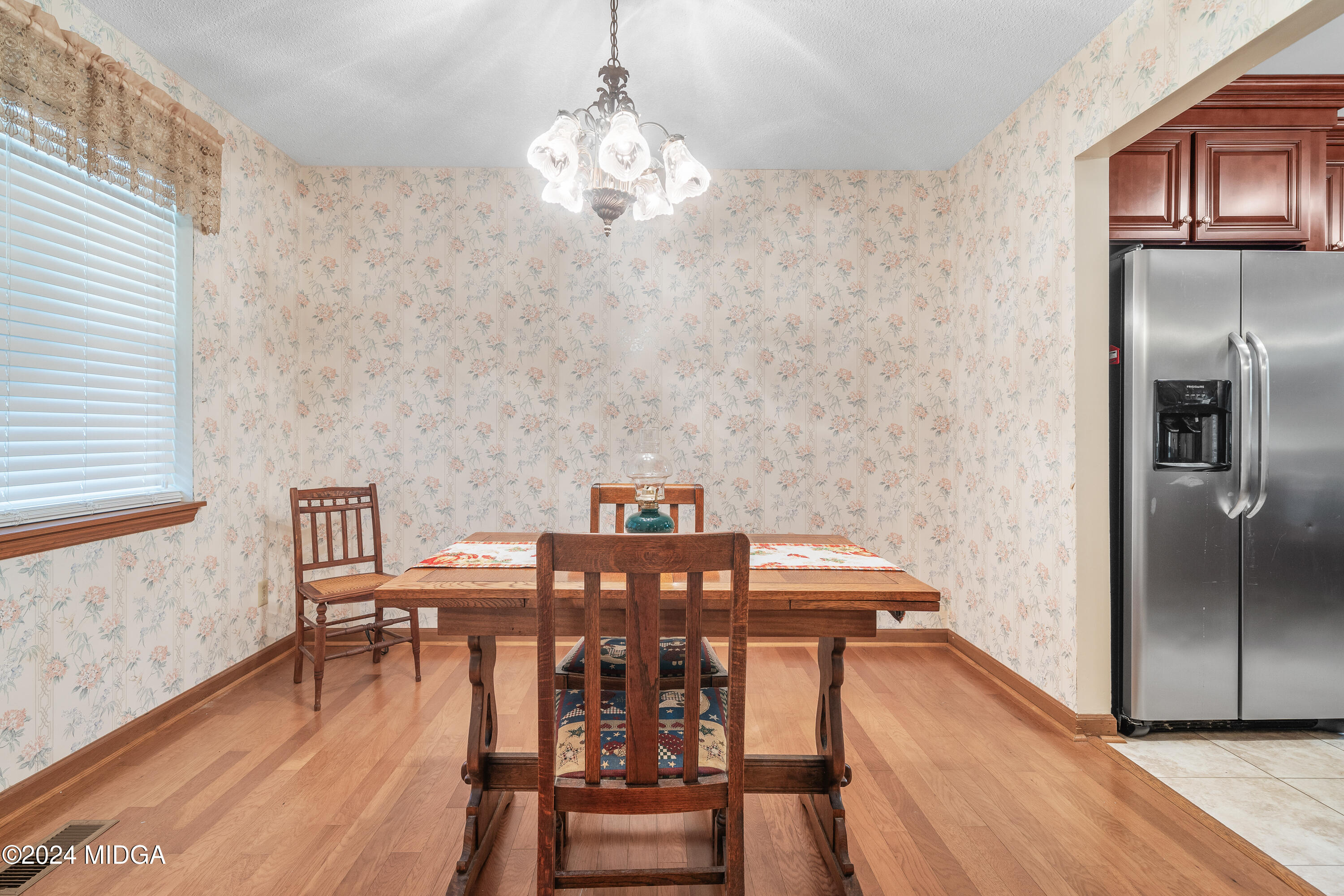 112 Whitehead Place Gray, GA 31032 - Photo 10 of 36 a view of a dining room with furniture wooden floor and chandelier