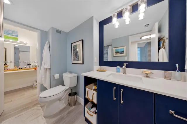 a view of bathroom with a sink mirror vanity and toilet