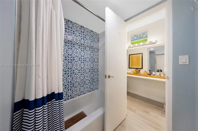 a bathroom with a bathtub and shower