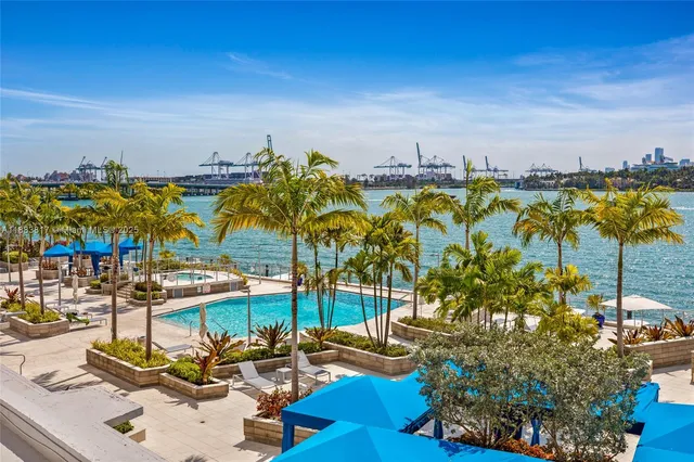 a view of a swimming pool with furniture