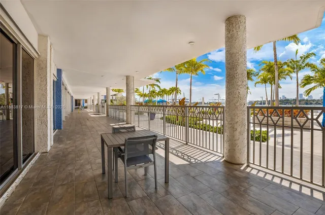 a dining room with furniture water view and wooden floor