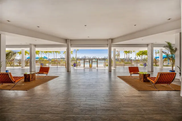 a living room with furniture and floor to ceiling window