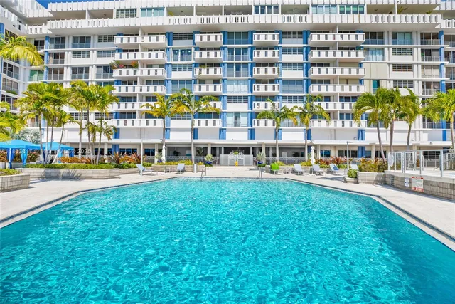 a large building with swimming pool in front of it