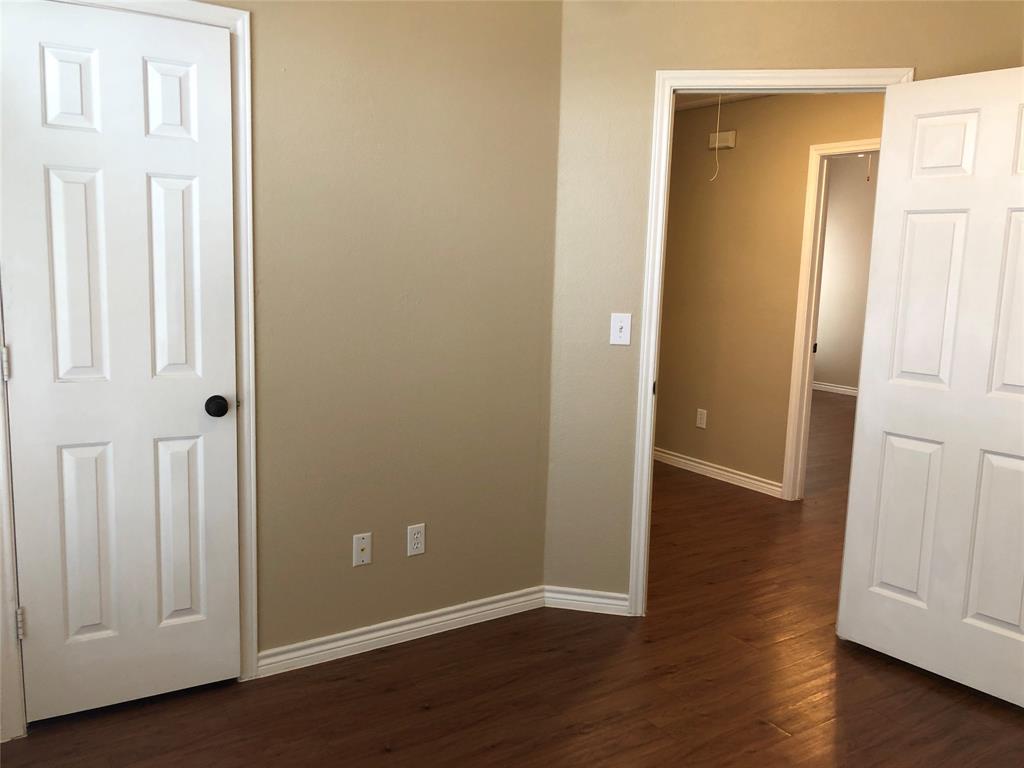 8301 Bells Street Frisco, TX 75035 - Photo 20 of 24 an empty room with wooden floor and closet area