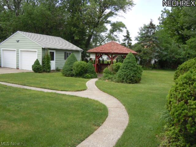 21863 Louis Road Bedford, OH 44146 - Photo 21 of 25 view of the backyard with the gazebo and 2 car detached garage in the backround