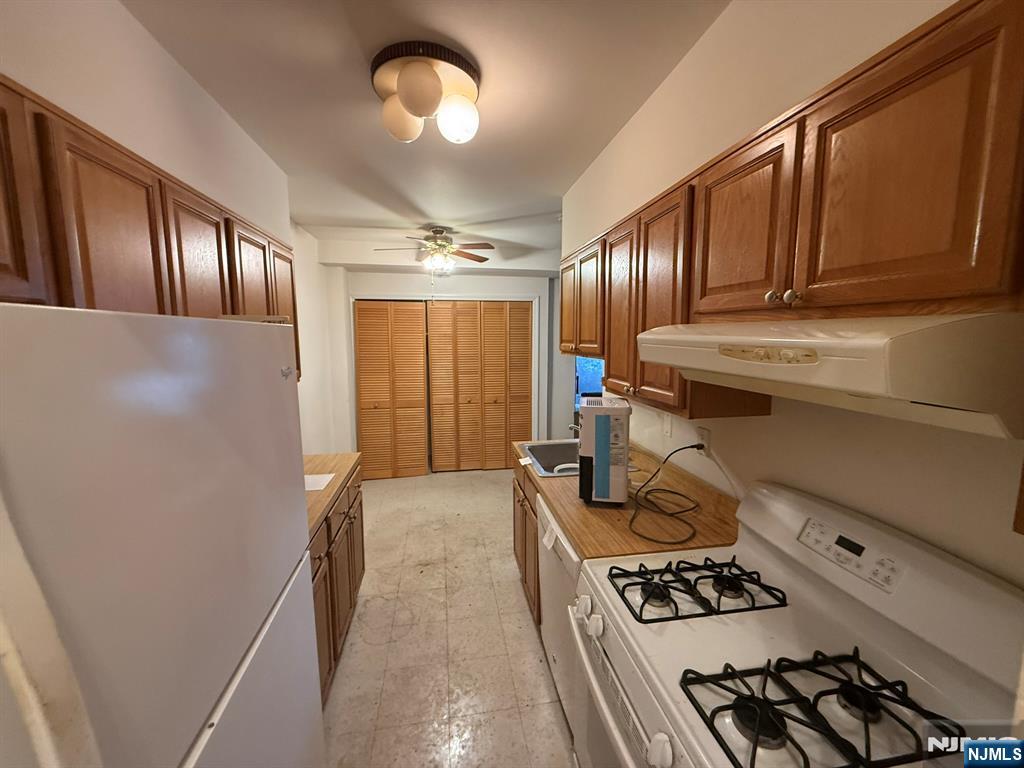 462 River Road, Unit C Nutley, NJ 07110 - Photo 2 of 10 a kitchen with stainless steel appliances granite countertop a stove refrigerator and cabinets