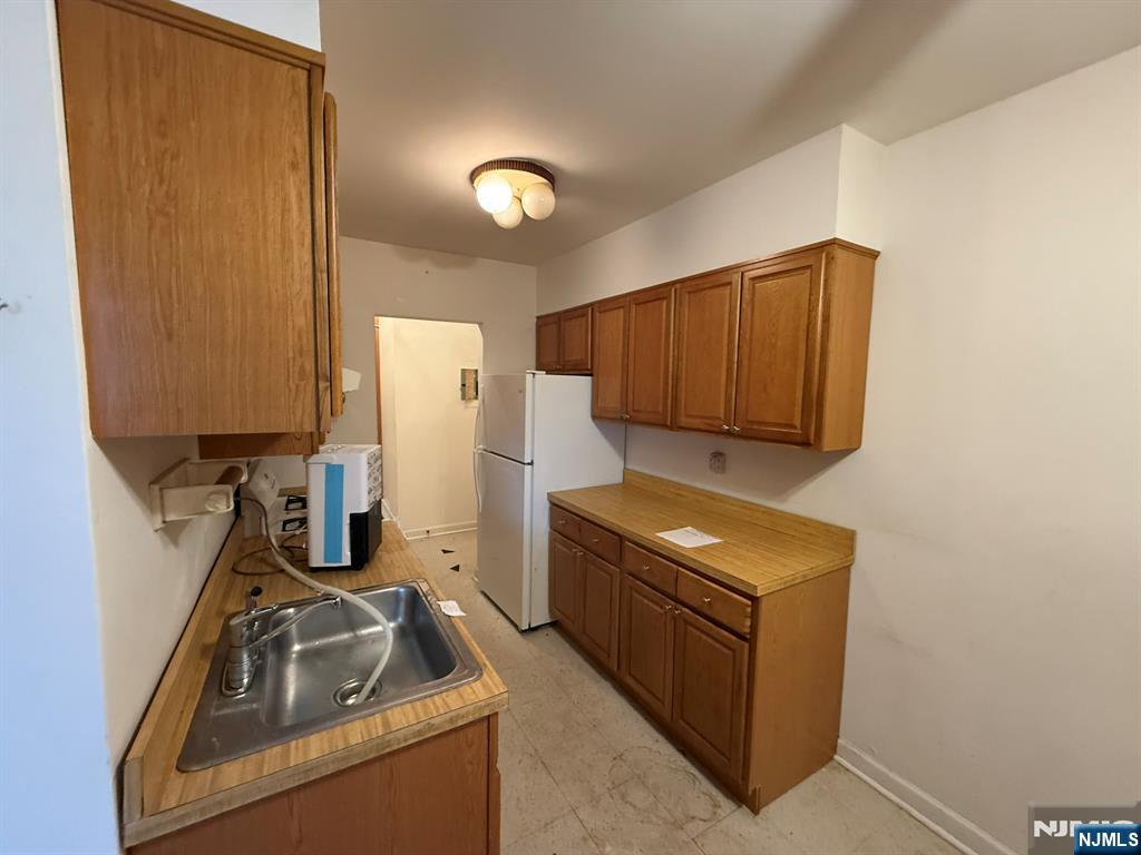 462 River Road, Unit C Nutley, NJ 07110 - Photo 3 of 10 a kitchen with granite countertop a sink stove and cabinets
