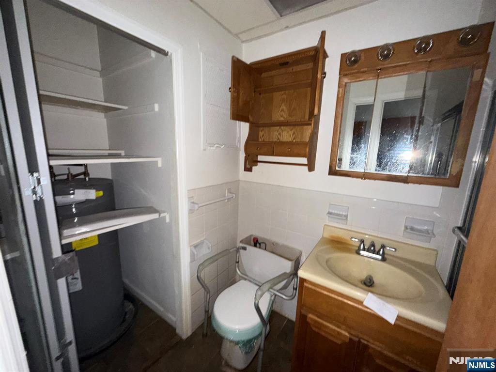 462 River Road, Unit C Nutley, NJ 07110 - Photo 8 of 10 a bathroom with a toilet sink and mirror