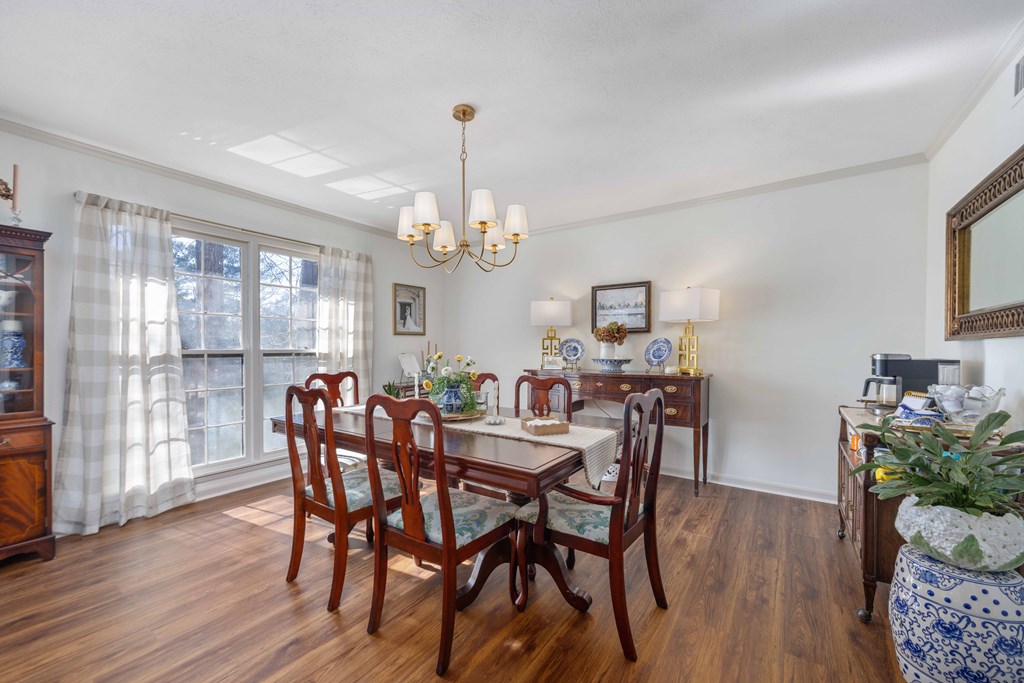 2525 Norris Road, Unit 98 Columbus, GA 31907 - Photo 6 of 40 a view of a dining room with furniture wooden floor and chandelier