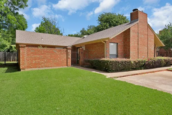 a view of backyard of house with green space