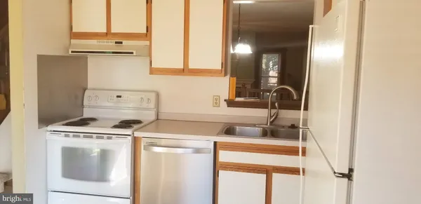 a kitchen with a stove and a sink