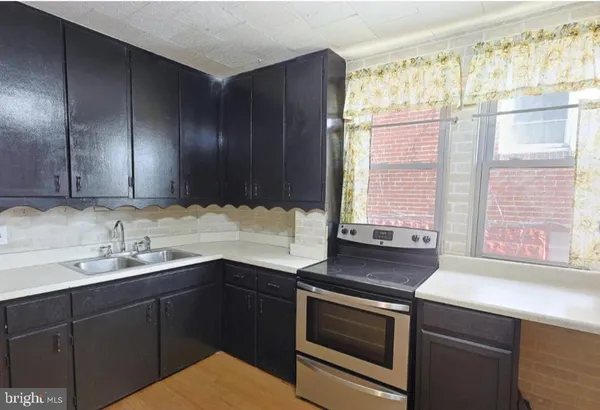 a kitchen with a sink and a window