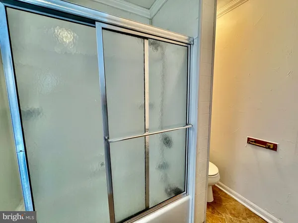a bathroom with a glass shower door