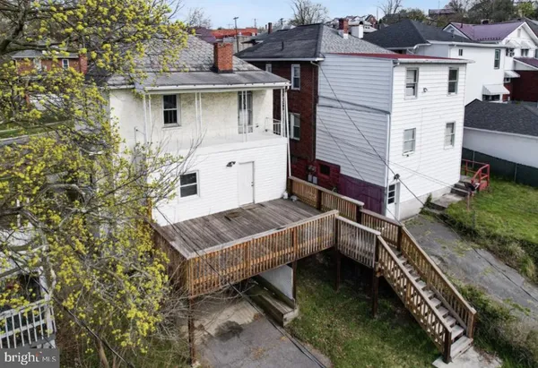a view of a house with a yard and sitting area