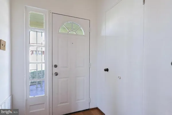 a view of an entryway with wooden floor