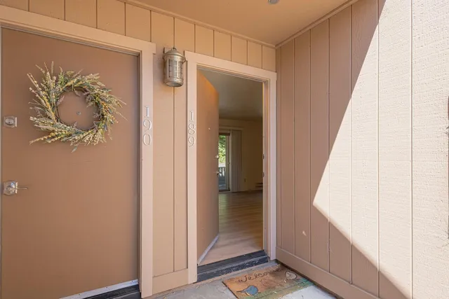 a view of a hallway with wooden floor and closet