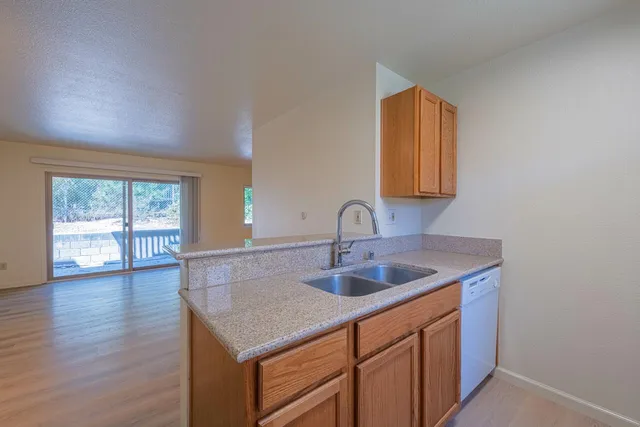 a kitchen with a sink cabinets and a wooden floor