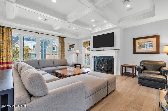 a kitchen with stainless steel appliances granite countertop counter space a sink and a living room view