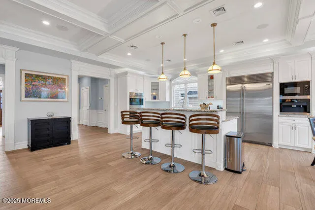 a view of a dining room with furniture and windows