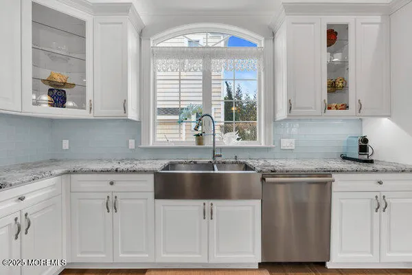a bedroom with a bed lamp and a large window