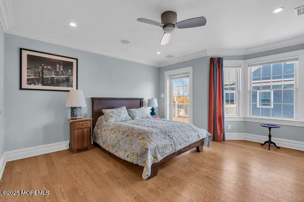 a living room with a bed furniture and a painting on the wall
