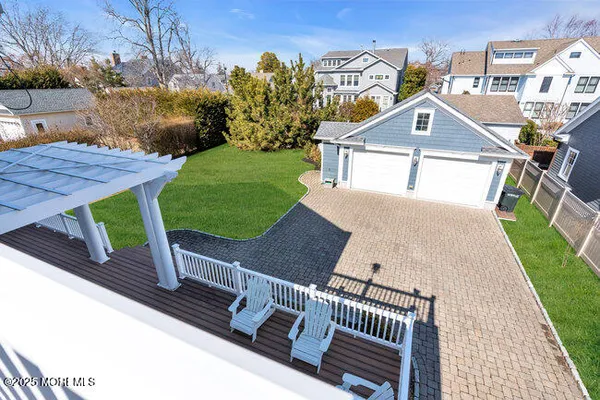a view of a patio with table and chairs with wooden floor and fence