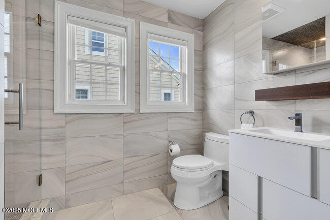 308 Pennsylvania Avenue Spring Lake, NJ 07762 - Photo 38 of 67 a bathroom with a toilet sink vanity and mirror