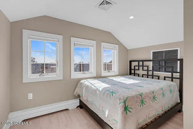 a view of a patio with table and chairs with wooden floor and fence