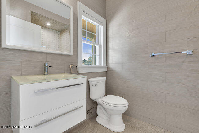 308 Pennsylvania Avenue Spring Lake, NJ 07762 - Photo 10 of 67 a bathroom with a toilet sink and mirror