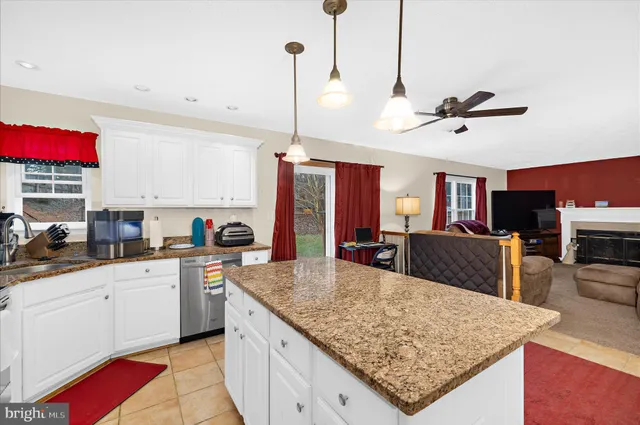 a kitchen with stainless steel appliances granite countertop a sink a stove top oven a counter space and cabinets
