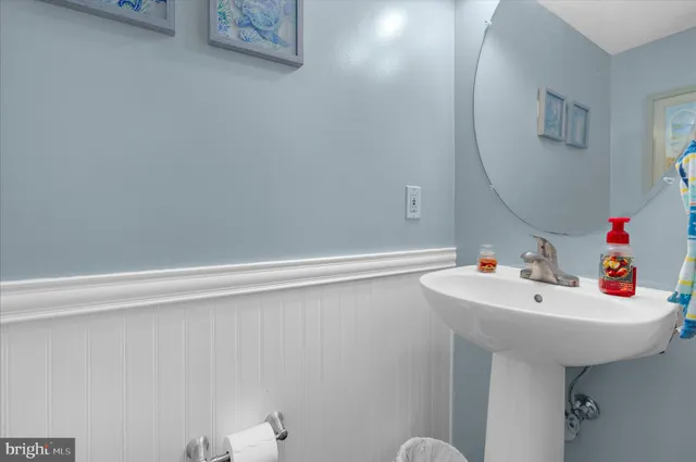 a bathroom with a sink a mirror and a toilet