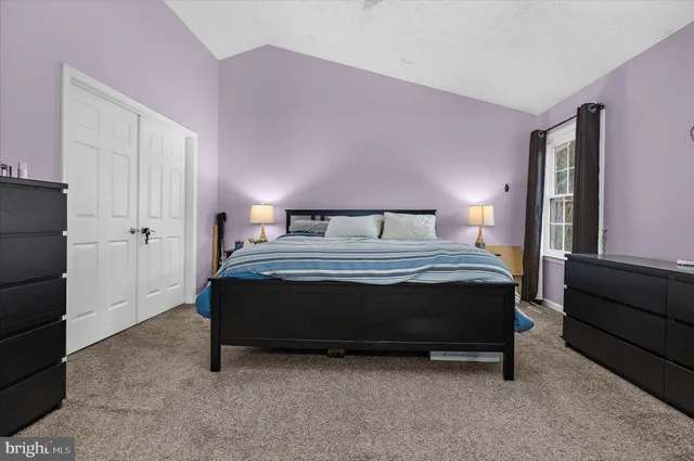 a spacious bedroom with a bed and a walk in closet