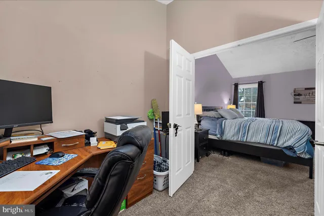 a bedroom with bed and a flat screen tv