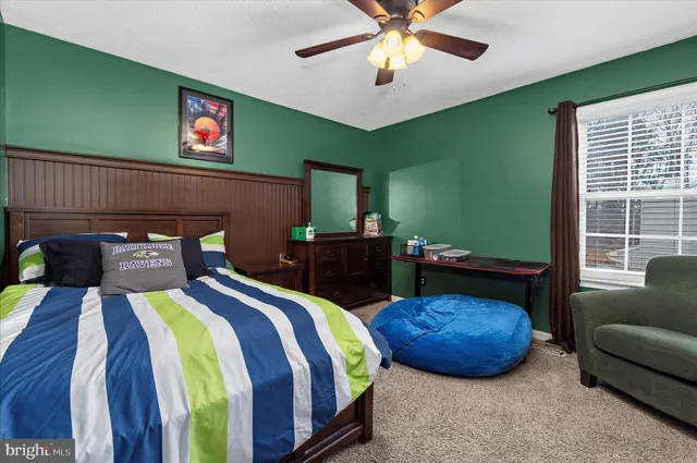 a bedroom with furniture and a flat screen tv