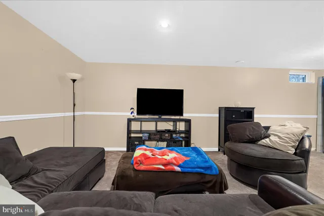 a view of a livingroom with wooden floor and cabinet