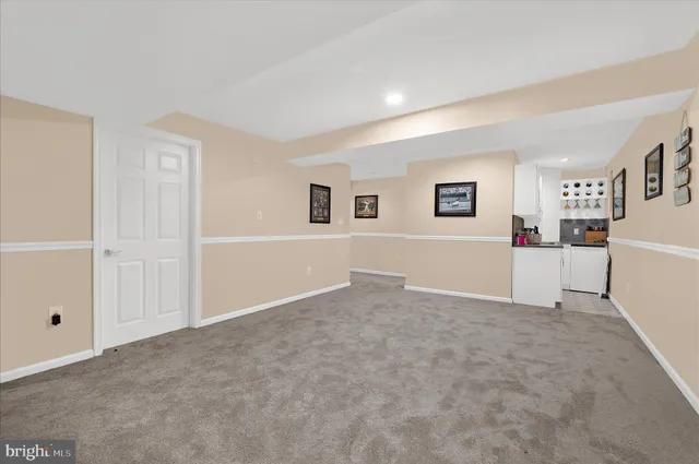 a living room with furniture and painting on the wall